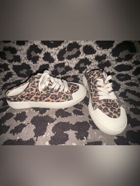 Leopard slip on sneakers.